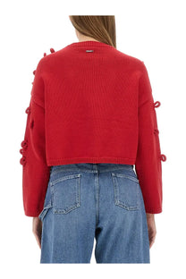 Jw anderson women’s red knitted cropped sweater with decorative button embellishments along the sleeves