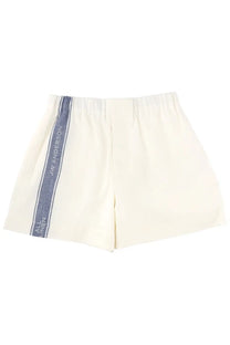 Jw anderson women’s cream elastic waist shorts with navy vertical stripe and white logo detailing