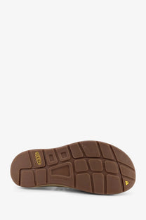 Brown rubber sole with textured tread and yellow keen logo on keen men’s uneek suede sneakers timberwolf