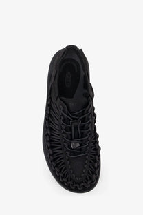 Keen men’s uneek woven fabric sandals in black featuring black woven leather with braided lacing and a minimalist design