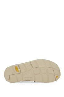 Beige rubber sole with yellow triangular logo and contour arch text on keen women’s uneek oak sandal multicolor