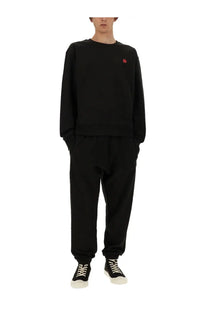 Kenzo men’s black long-sleeved sweatshirt with a small red embroidered flower on the left chest