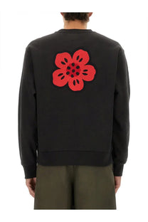 Kenzo men’s classic black sweatshirt with bold red crocheted flower patch on the back side