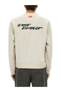 Back view of kenzo men’s classic sweatshirt grey heather gray with black cursive 18 rue dunne lettering and red brand tag