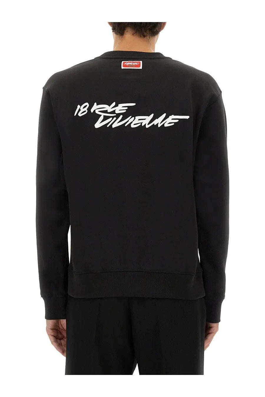 Back of black kenzo men’s cotton crewneck sweatshirt with white 18 rue divine script and small red logo at neckline