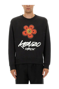 Kenzo men’s black cotton sweatshirt with bold orange flower graphic and white kenzo paris lettering