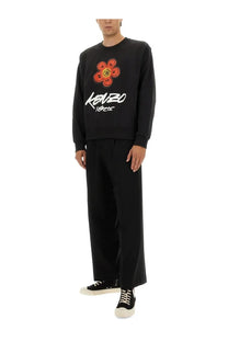 Kenzo men’s black cotton sweatshirt with bold orange floral graphic yellow center and white script lettering