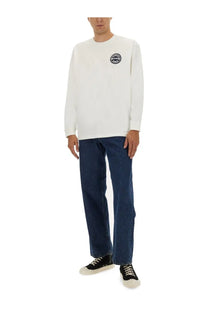 Kenzo men’s white long sleeved crewneck sweatshirt with black circular logo on left chest in cotton material