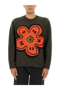 Kenzo men’s olive green knit sweater with a bold orange flower and yellow geometric center design