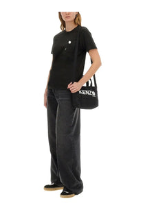 Kenzo women’s boke flower pin shirt black paired with a black kenzo crossbody bag with white logo and striped strap