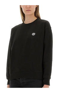 Kenzo women’s black cotton crewneck sweatshirt with a small white embroidered tiger logo on the left chest