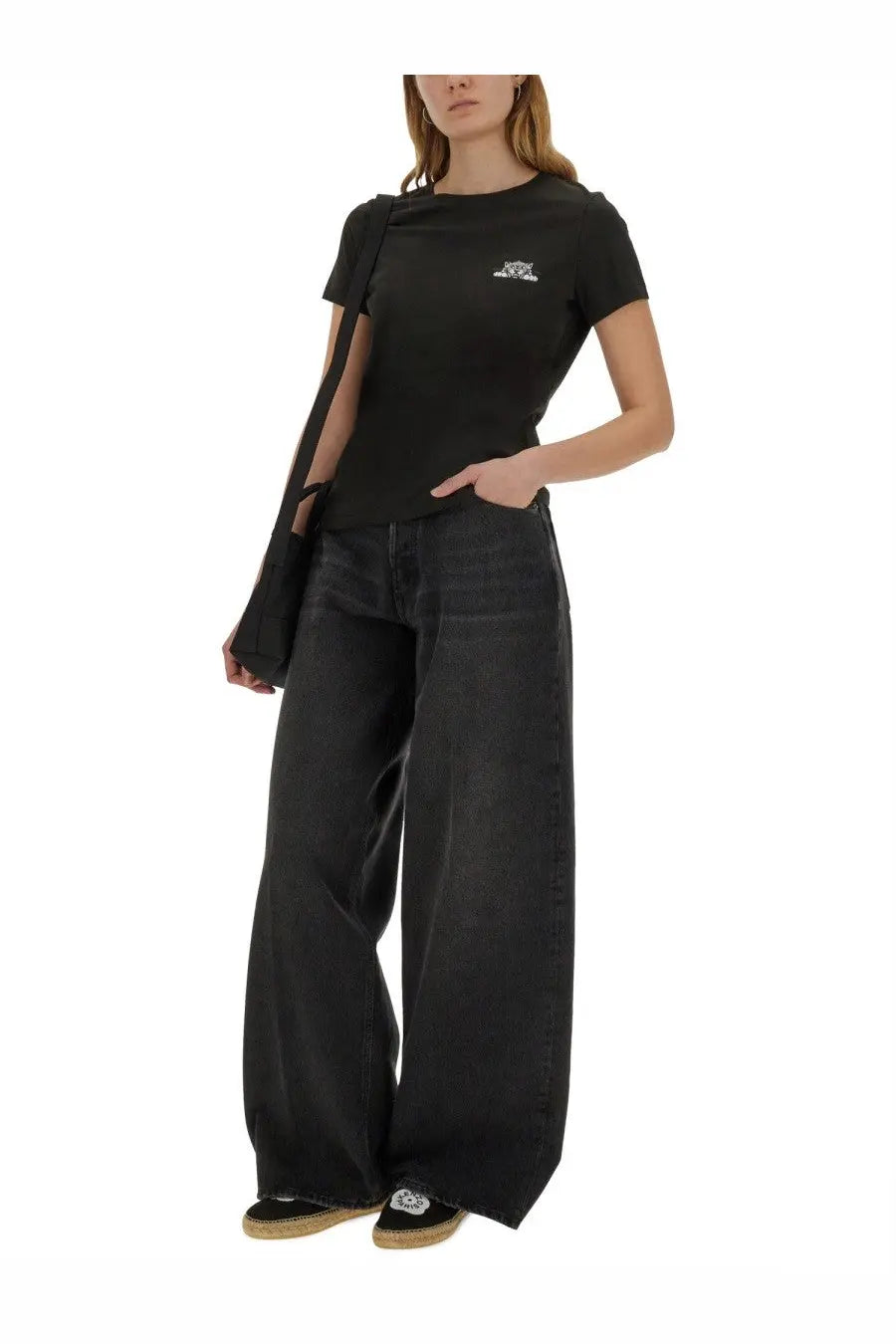 Black wide-leg denim jeans with relaxed fit and subtle fading paired with kenzo women’s happy tiger shirt black