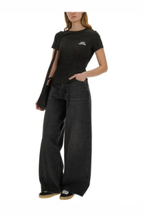 Black wide-leg denim jeans with relaxed fit and subtle fading paired with kenzo women’s happy tiger shirt black