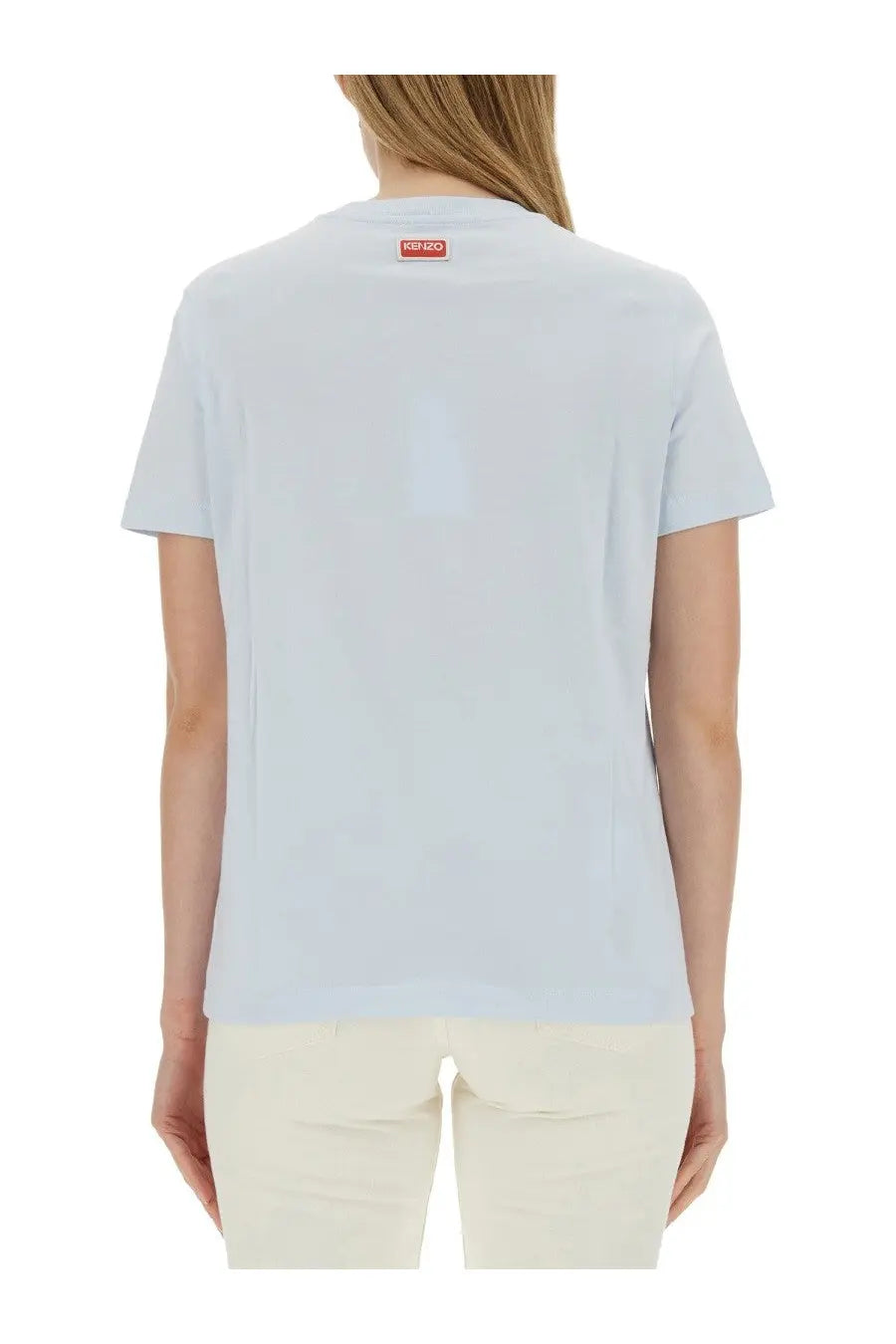 Kenzo women’s light blue cotton shirt showing the back with a small red rectangular Kenzo logo tag at the neck