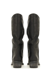 Khaite women’s black leather knee-high boots with matte finish and low block heels shown from the back side
