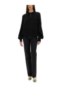 Black oversized knit sweater with collar and button front paired with khaite women’s jeans danielle black