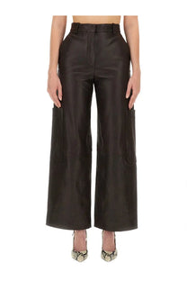 Khaite women’s black leather cargo pants with wide legs and side pockets in a back view