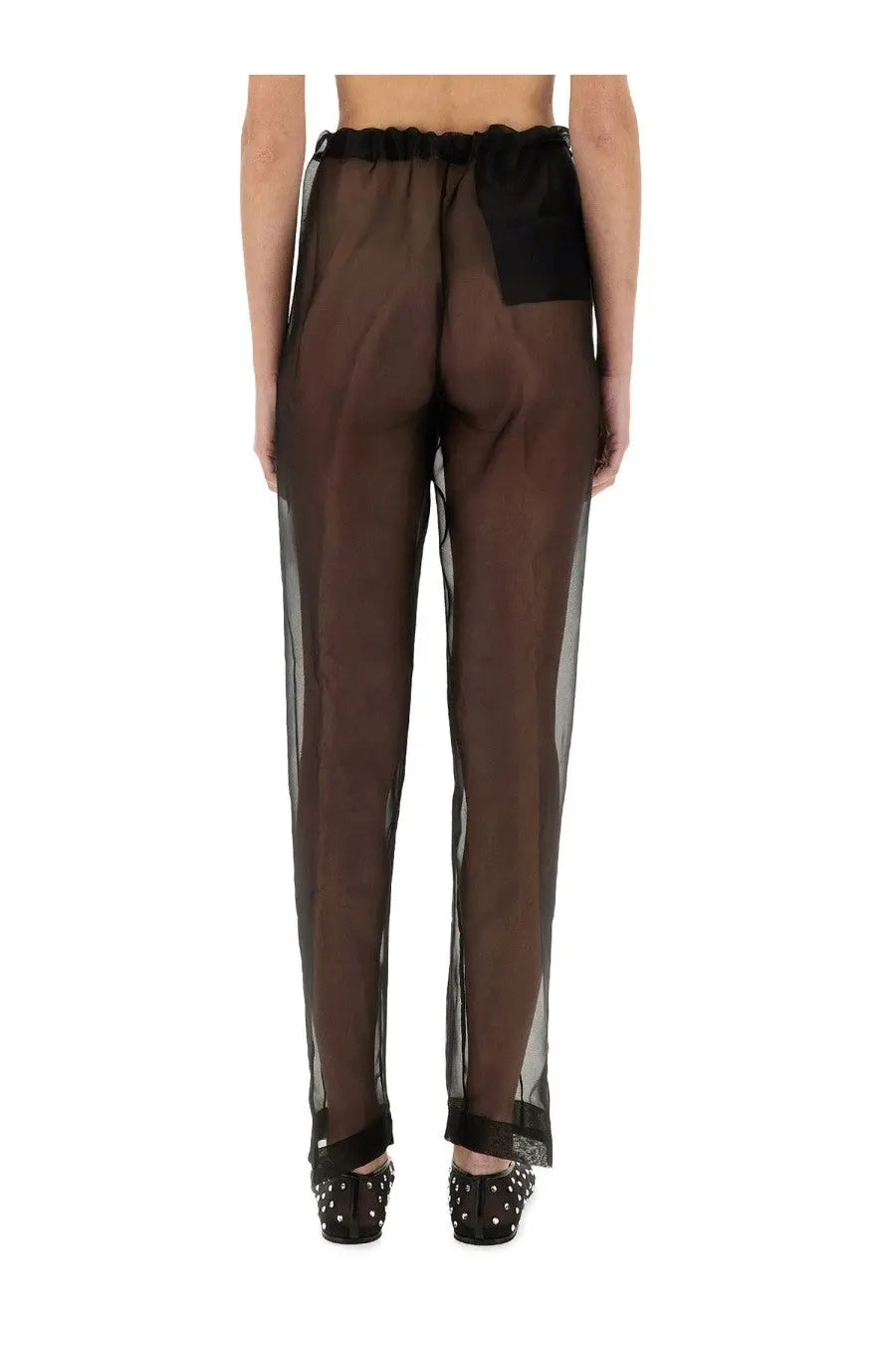 Brown sheer trousers with black elastic waistband and matching back patch shown from the back by Khaite Women