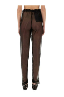 Brown sheer trousers with black elastic waistband and matching back patch shown from the back by Khaite Women