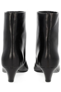Khaite women’s Stivale Arizona black patent leather ankle boots with a sleek glossy finish and low block heel