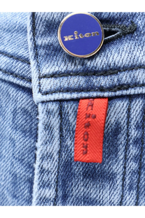 Kiton men’s blue denim jeans with a circular blue and gold Kiton button and an orange brand tag on the front waistband