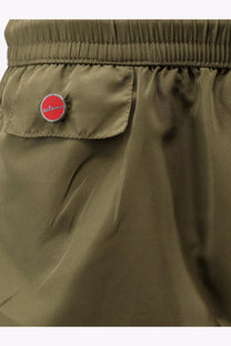 Kiton men’s olive green nylon swim trunks with a red circular logo patch on the front pocket