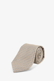 Beige silk tie with subtle navy blue dot pattern from Kiton men’s silk tie multicolor collection