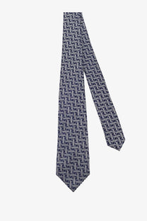Kiton men’s silk tie in navy blue featuring a subtle white geometric pattern and multicolor accents