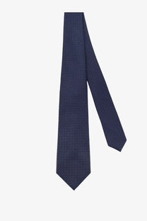 A navy blue silk tie by Kiton featuring a subtle repeating geometric pattern in multicolor design