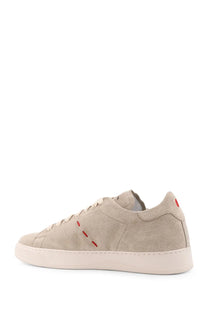 Kiton men’s beige suede low-top sneaker with red stitching accents and a white rubber sole
