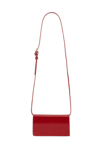 A sleek glossy red leather kiton women’s kros crossbody bag with a slender adjustable strap and minimalist design