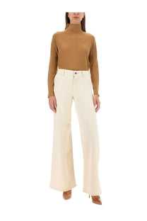 Cream-colored wide-leg trousers with a clean tailored fit paired with kiton women’s beige turtleneck shirt