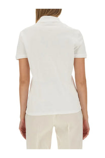 Lacoste women’s white polo shirt with short sleeves, classic collar, and neatly stitched hem in cotton material