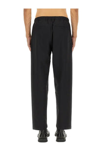 Back view of laminar men’s comfort tech black tapered trousers with elastic waistband and two rear pockets