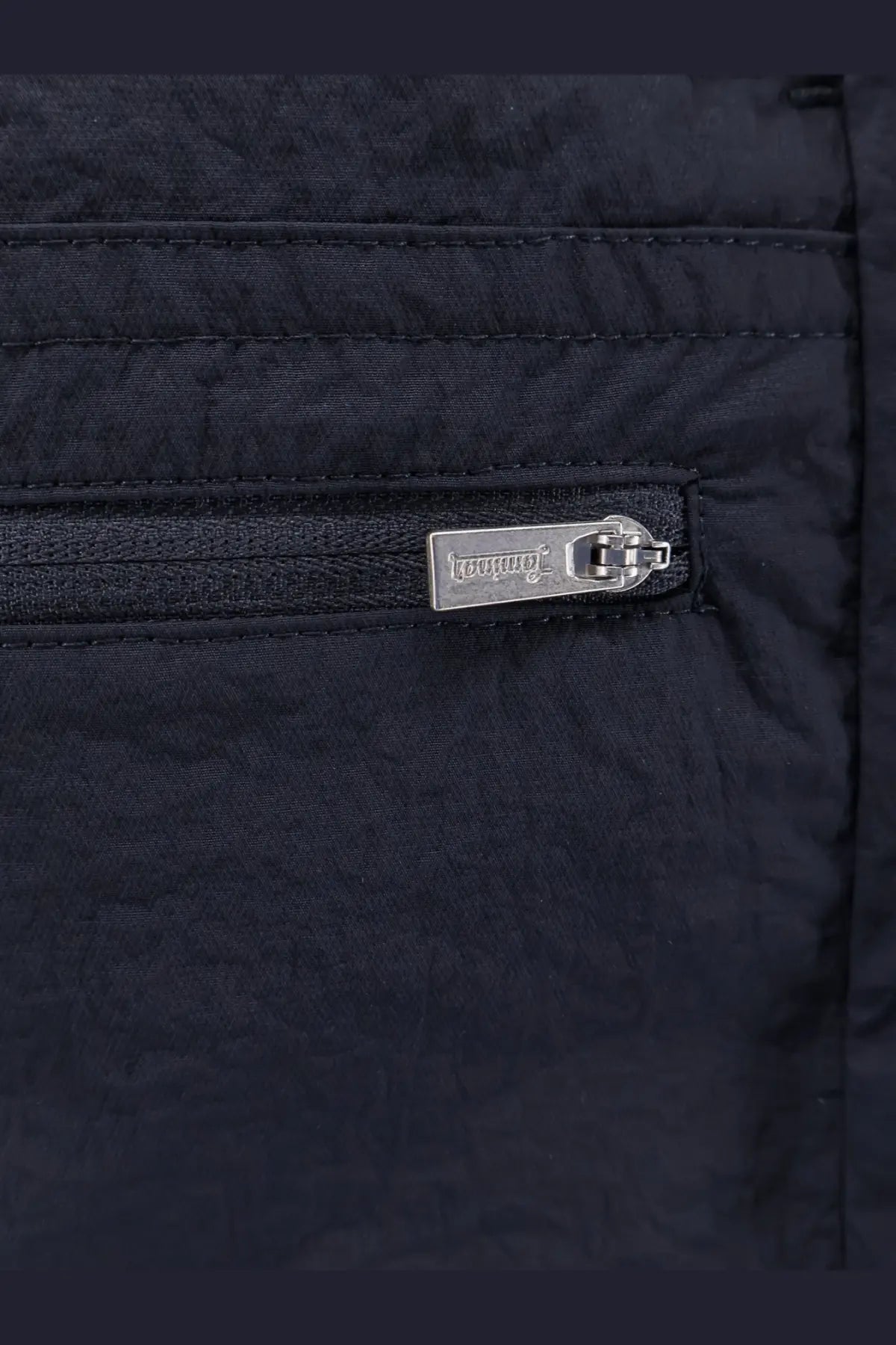 Black quilted nylon jacket with silver toned dolce &amp; gabbana logo zipper pull paired with blue laminar men’s nylon bermuda shorts