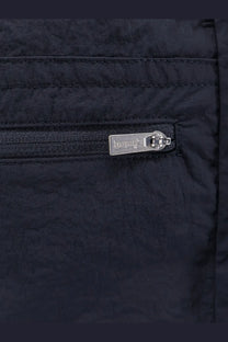 Black quilted nylon jacket with silver toned dolce &amp; gabbana logo zipper pull paired with blue laminar men’s nylon bermuda shorts