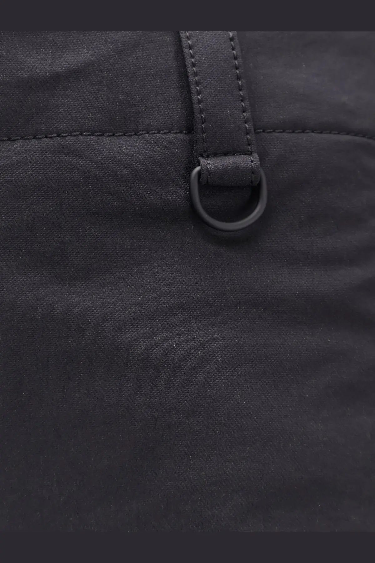 Black nylon bag with matching leather strap and metal ring shown with laminar men’s technical fabric trousers black