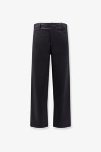 Black laminar men’s technical fabric wide-leg trousers with sleek modern cut and subtle side seam detailing
