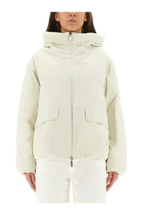 Laminar women’s cream-colored Goretex puffer jacket with hood front zipper and two flap pockets with white buttons