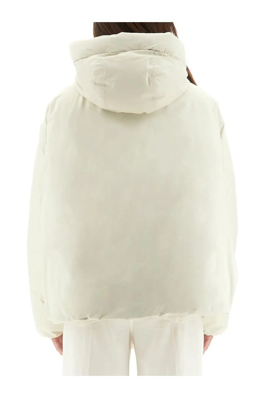 Cream-colored laminar women’s goretex puffer jacket with quilted design and hood for cold weather protection