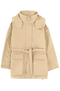 Beige laminar women metallic parka with belted waist, large front pockets, and snap-buttoned shoulder epaulets