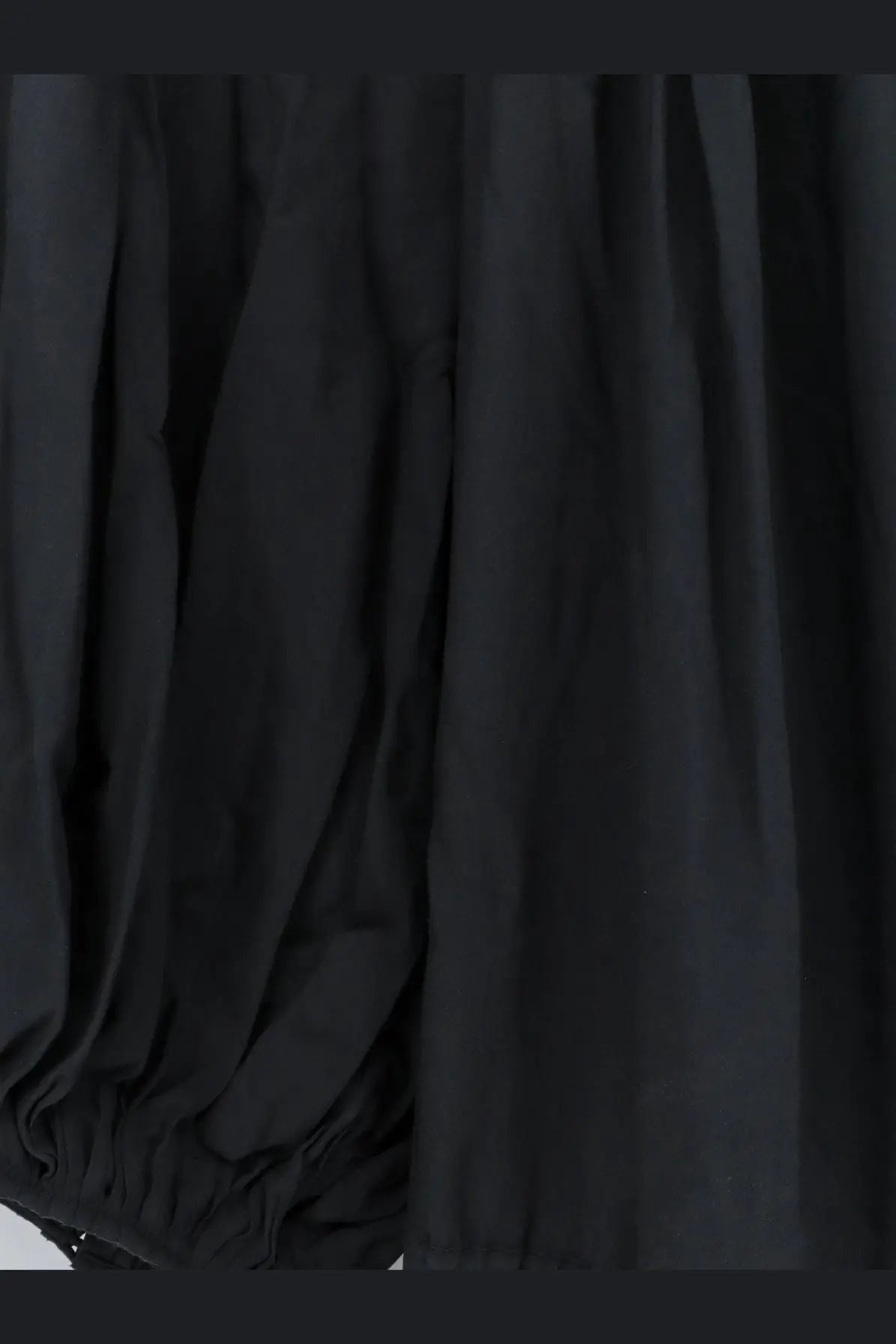 Black flowing fabric with soft folds and gathered hem of lamrons womens modal and silk blend dress grey back side