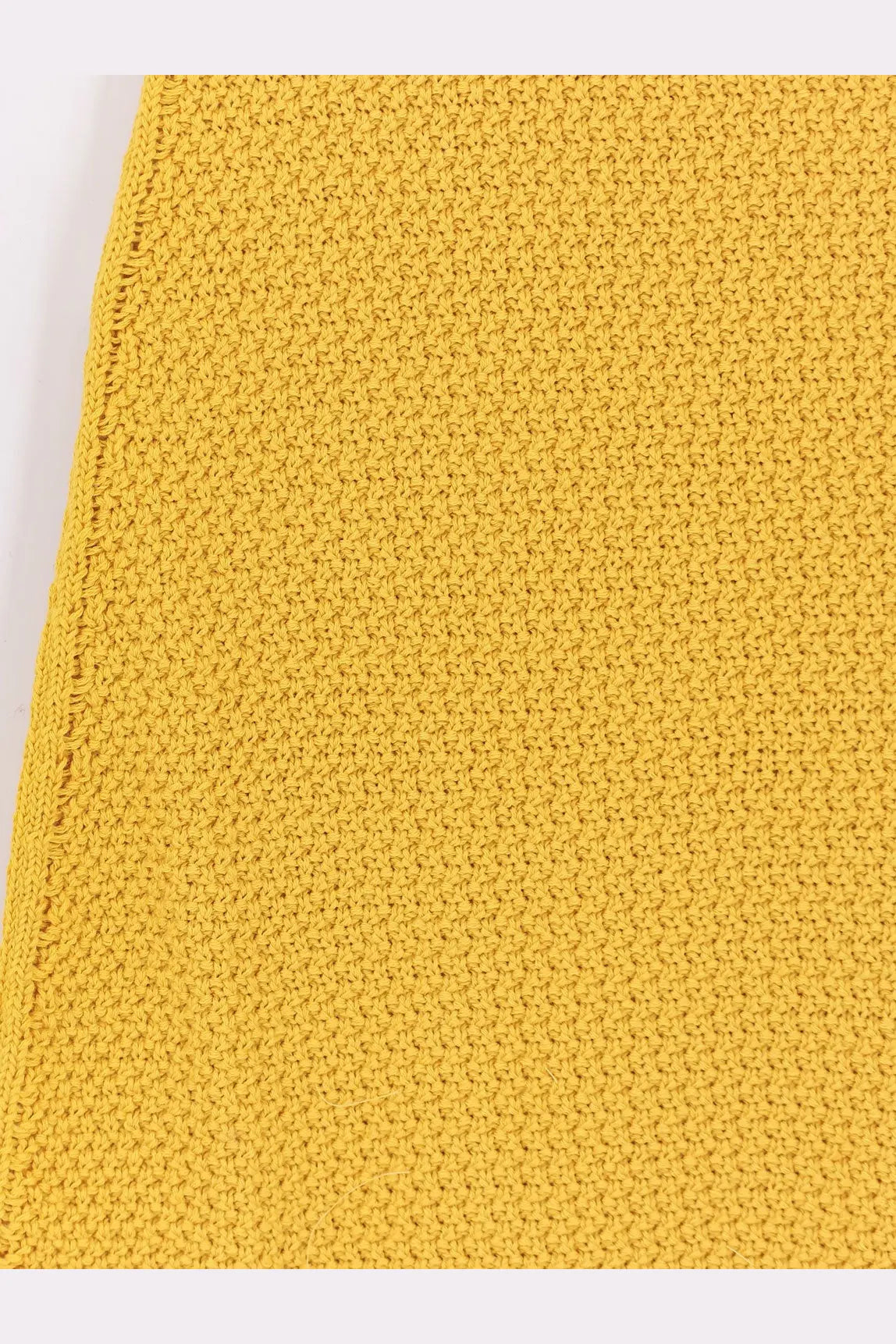 A vibrant yellow knitted cotton fabric with a textured stitch pattern on laneus women’s cotton dress zafferano