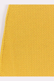 A vibrant yellow knitted cotton fabric with a textured stitch pattern on laneus women’s cotton dress zafferano