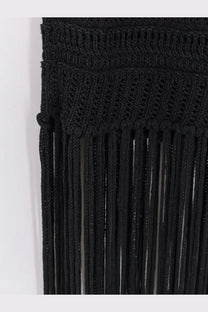Black knitted macrame wall hanging with fringe complementing Laneus women’s viscose and recycled polyester dress black
