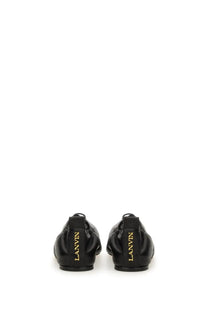 Black leather lanvin women’s lace up ballet flats with gold lettering on the heel showing the back side