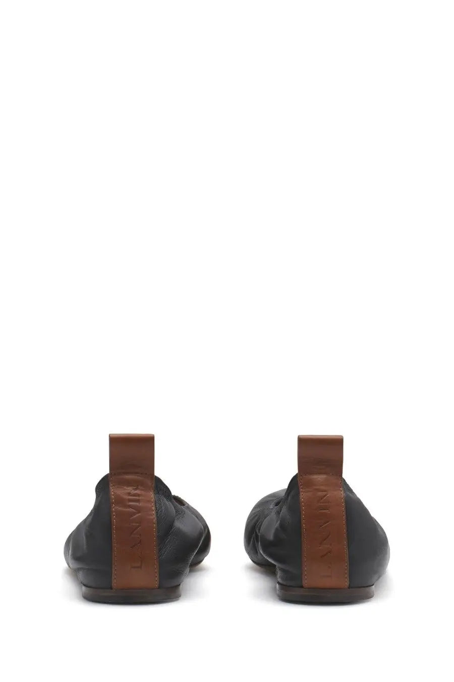 Black leather loafer shoes with brown leather pull tabs and lanvin brand embossing on the back side
