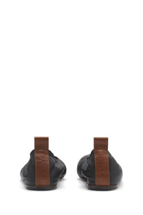 Black leather loafer shoes with brown leather pull tabs and lanvin brand embossing on the back side