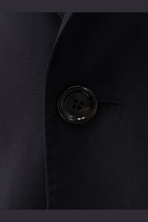 Black glossy four-hole button set into dark fabric on lardini men’s iconic single breasted pure virgin wool blue suit