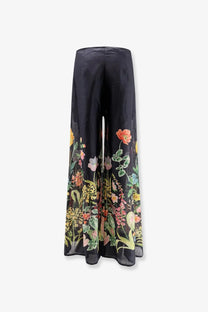 Lavi women’s frangipane ramié beige trousers with black wide-leg and vibrant colorful floral print cascading down